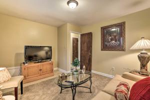 a living room with a tv and a table at Family Home Near Panola Mountain State Park! in Woodstream