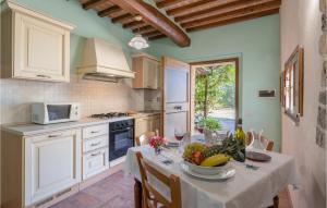 a kitchen with a table with a bowl of fruit on it at Fresia in Pieve a Scuola