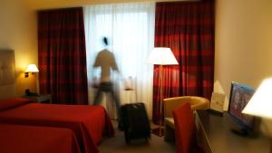 Postel nebo postele na pokoji v ubytování Garden Hotel