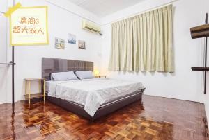 a bedroom with a large bed and a window at B&B Matu Road, Sibu in Sibu