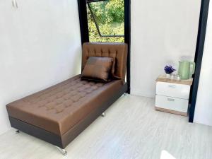uma cama num quarto com uma janela em p.p. hill & house em Ban Tha Phae