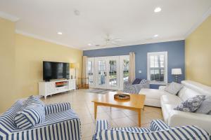 a living room with couches and a tv at Waterfront luxury Villa 29 with sunset views and boat slip townhouse in Marathon