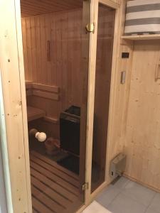 a sauna with a glass door in a room at Appartement Bergwaerts in Rickenbach