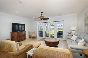 a living room with a couch and a tv at Waterfront luxury Villa 34 with sunset views and boat slip townhouse in Marathon