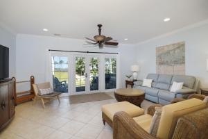 a living room with a couch and a tv at Waterfront luxury Villa 34 with sunset views and boat slip townhouse in Marathon