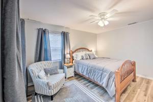 a bedroom with a bed and a chair and a ceiling fan at Longview Vacation Rental Home 4 Mi to Dtwn in Longview