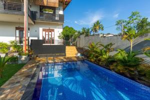 a swimming pool in the backyard of a house at Yamu Lanka Inn in Malabe