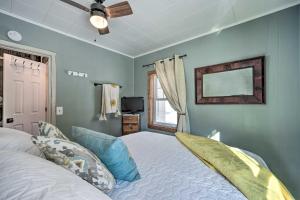 a bedroom with a bed and a ceiling fan at Family Home - Walk to Town and Balsam Lake! in Balsam Lake