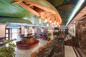 a hotel lobby with a mural on the ceiling at Grand Fleuve Boutique in Ha Long