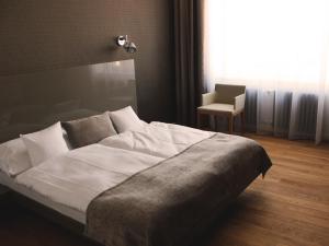 Postel nebo postele na pokoji v ubytování Hotel Lev