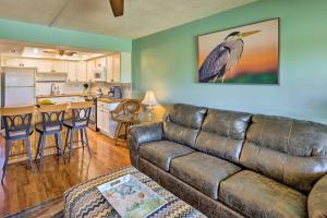 a living room with a couch and a kitchen at Sunny St Augustine Condo with Community Pool! in St. Augustine
