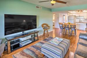 a living room with a large flat screen tv at Sunny St Augustine Condo with Community Pool! in St. Augustine