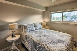 a bedroom with a bed with a lamp and a window at Sunny St Augustine Condo with Community Pool! in Saint Augustine +28 photos
