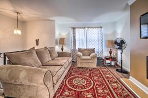 a living room with a couch and a chair at Maryland Vacation Home Near US Capital! in Riverdale Park