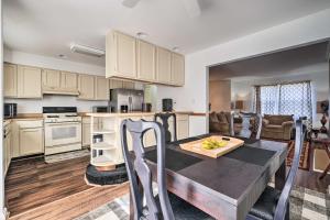 a kitchen and living room with a wooden table in a room at Maryland Vacation Home Near US Capital! in Riverdale Park