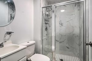 a bathroom with a shower and a toilet and a sink at Maryland Vacation Home Near US Capital! in Riverdale Park +20 photos