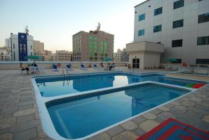 a swimming pool on the roof of a building at Baisan International Hotel in Manama