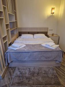 a bedroom with a bed with two towels on it at Дом in Gyumri