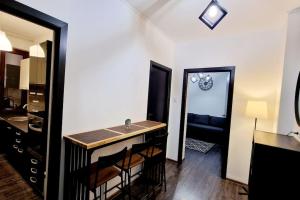 a kitchen with a sink and a mirror in a room at Belle Apartments - Republicii in Piteşti