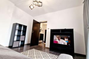 a living room with a flat screen tv in a fireplace at Belle Apartments - Republicii in Piteşti