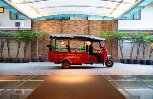 a small red golf cart parked in a building at The Mercer Sukhumvit 4 in Bangkok