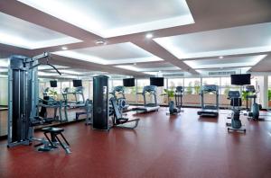 a gym with a lot of treadmills and machines at The Mercer Sukhumvit 4 in Bangkok