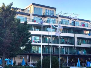 a hotel building with flags in front of it at Hotel Pacific Palma in Sunny Beach