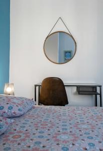 a bedroom with a bed and a mirror on the wall at Le 482 - Grand Appartement design & Confort - 4 chambres in Vichy