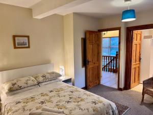 a bedroom with a bed and a door to a balcony at Ashfield Bed & Breakfast in Belfast