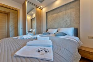 um quarto com 2 camas e toalhas em Mount Inn La Boheme em Zlatibor