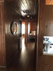 a hallway of a house with a wooden floor at BlackBeard's Retreat - Historic and Pet Friendly cottage in Kitty Hawk