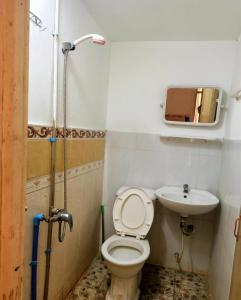 a bathroom with a toilet and a sink at Good Luck Hostel in Phnom Penh