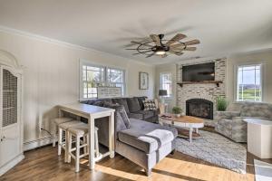 a living room with a couch and a fireplace at Mattituck Home with Fireplaces - Near Wineries in Mattituck