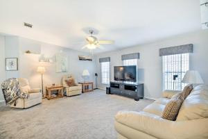 a living room with couches and a flat screen tv at Wildwood Vacation Rental Near Golf and Dining! in Wildwood
