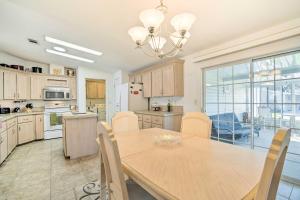 a kitchen with a wooden table and a dining room at Wildwood Vacation Rental Near Golf and Dining! in Wildwood