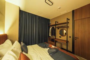 a bedroom with a bed and a mirror at The Kailyn Hotels&Suites Ataşehir in Istanbul