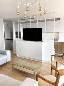a living room with a flat screen tv on a counter at Fabuleuse vue mer-Appart 110 m2 - métro et bus in Marseille