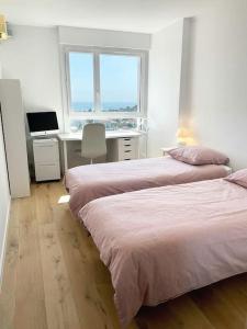 1 dormitorio con 2 camas y escritorio con ordenador en Fabuleuse vue mer-Appart 110 m2 - métro et bus, en Marsella