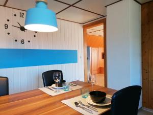 a dining room with a table and a clock on the wall at Like on cloud nine - Apartment in Emmental 