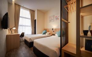 Postel nebo postele na pokoji v ubytování U Hotel Penang