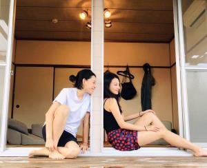 two women sitting on the floor in a room at Live here like local Japanese do in Kirishima