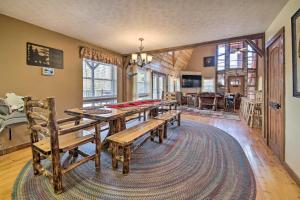 a dining room with a table and benches in a room at Strawberry Plains Cabin Private Pond and Game Room! in Strawberry Plains
