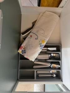 a drawer in a refrigerator filled with utensils at La Magara in Civita
