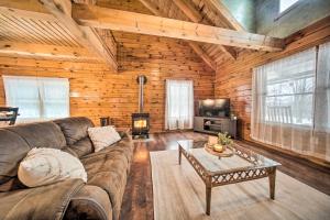 a living room with a couch and a coffee table at Cabin in Lake Chautauqua on 36 Acres with Hot Tub! in Ashville
