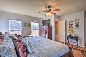 Un dormitorio con una cama y un ventilador de techo. en Charming Palmer Family Home on 5 Acres!, en Palmer