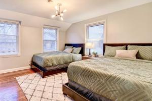 a bedroom with two beds and two windows at Luxurious Detroit Home - Walk to Golf and Park! in Detroit