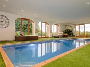 a large swimming pool in a house with windows at Annex by the Bain in Kirkby on Bain