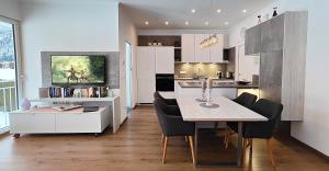 a kitchen and dining room with a table and chairs at Unterschlupf in Ebensee