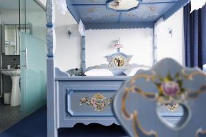 a bedroom with a blue and white bed with a sink at Komplettes Hotel mit 10 Zimmern in Bad Ragaz +41 photos