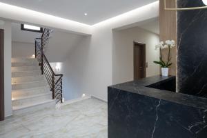 a staircase in a house with black marble at VagAthan - Lux Holidays in Afitos